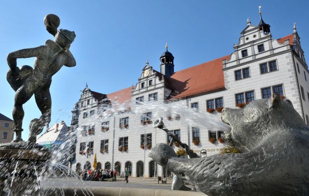 Bears and other stone figures spouting water into a fountain in front of the Renaissance town hall in Torgau.