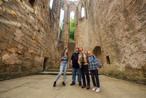 A family standing inside the old ruins of Oybin Monastery